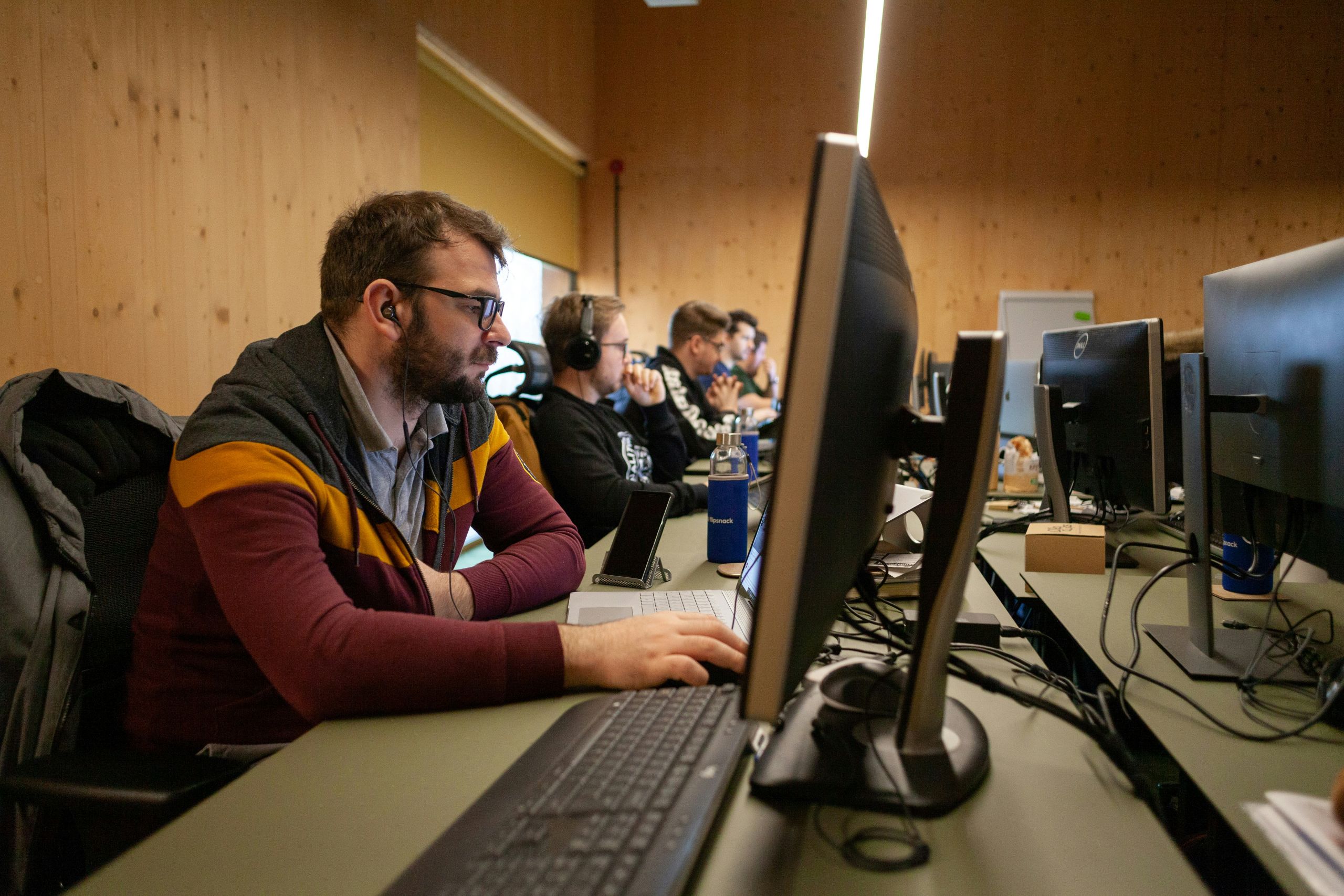 Row of IT professionals working in an office.